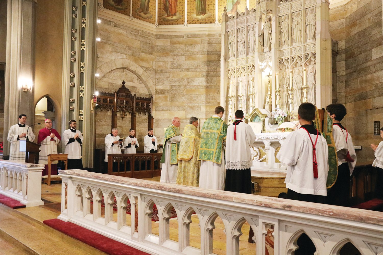 Bishop Thomas J. Tobin attended the Mass, in choir, at left, along with his master of ceremonies and a diocesan seminarian, as Father John Berg celebrates Mass in the traditional Latin form.